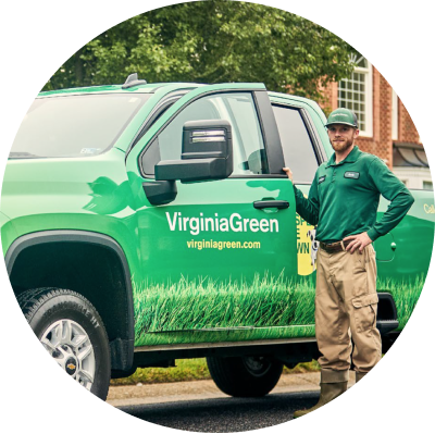 employee in front of company truck